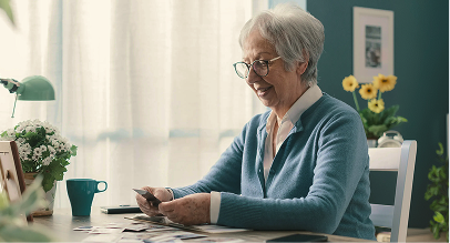 an elderly woman looking at a photo