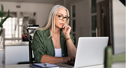 a woman looking at a laptop