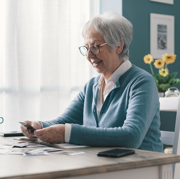 an elderly woman looking at a photo