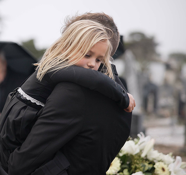a daughter with her father at a funeral service