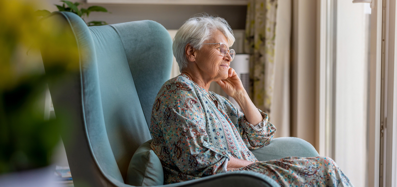 an elderly woman looking out the window